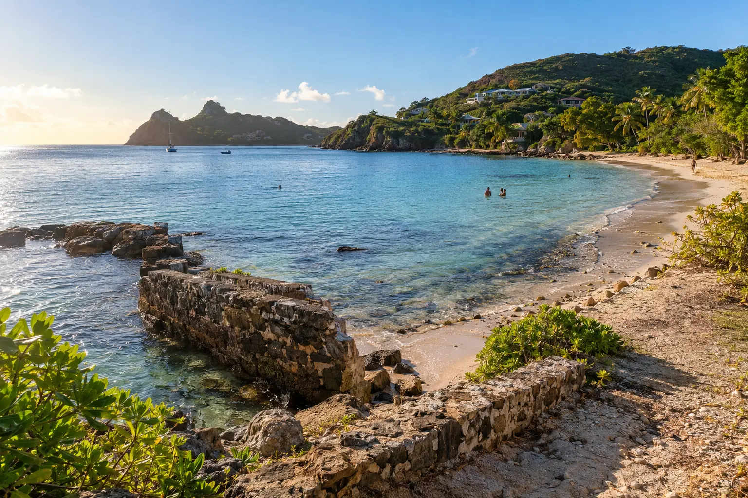 Freeman’s Bay at Galleon Beach with historic stone remains and swimmers