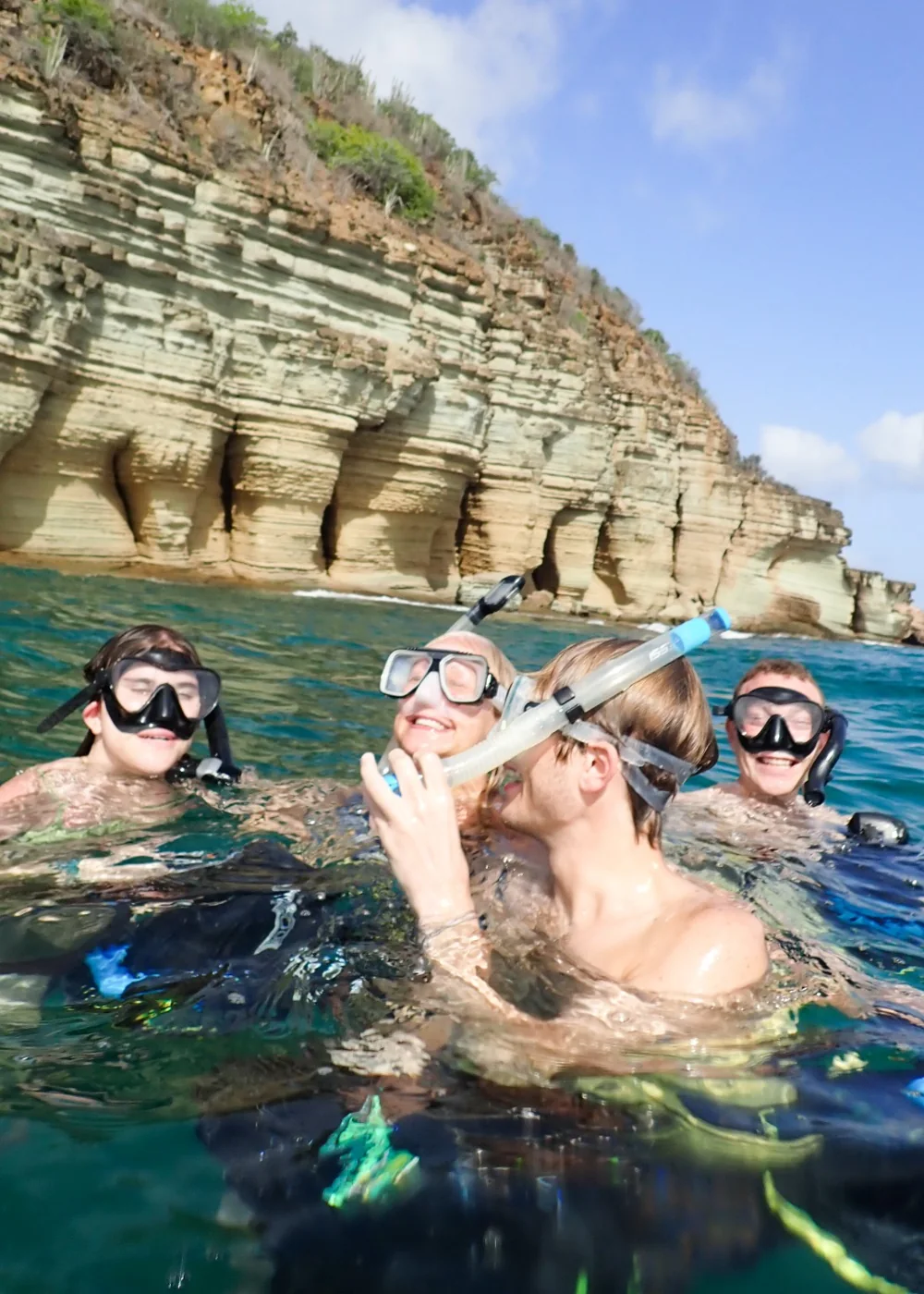 Smiling snorkeling guests beside the Pillars of Hercules