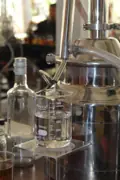 Close view of a small still and glassware at the Academy of Rum