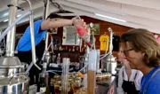 Academy of Rum guest creating a personalized rum blend at a small pot still