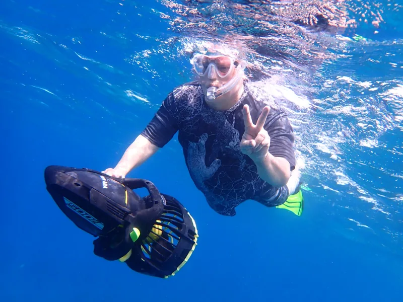 Guests preparing snorkeling equipment with sea scooters at Galleon Beach