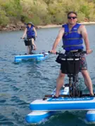 Guest in a blue flotation vest riding a Sea Cycle water bike