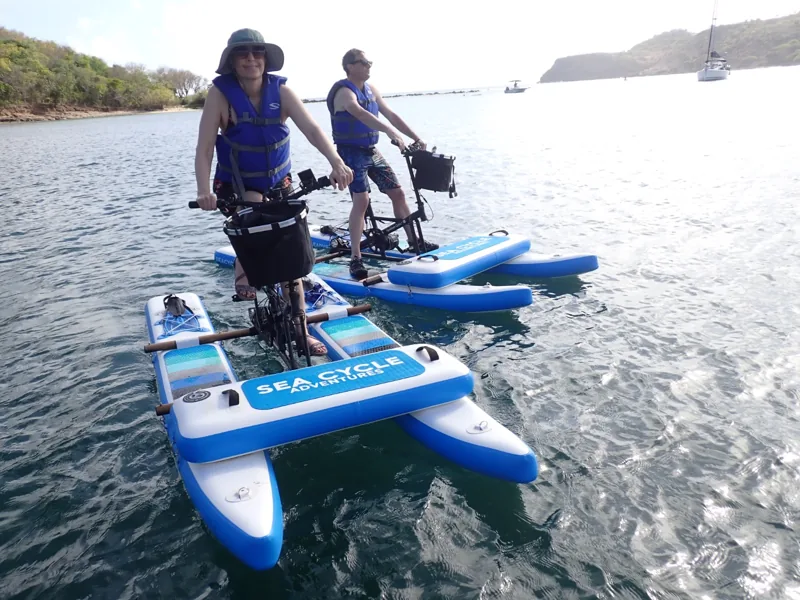 Electric sea cycles moving through the English Harbour setting