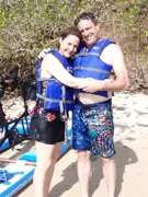 Two guests wearing flotation vests beside their Sea Cycle water bikes