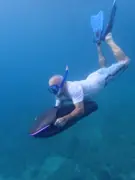 SeaNXT rider dipping below the surface with fins