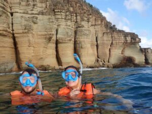 Skylork Scooter Snorkeling group of two explores the Pillars of Hercules near Antigua from Galleon Beach