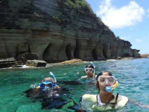 Skylork Scooter Snorkeling group of three explores the Pillars of Hercules near Antigua from Galleon Beach